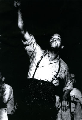 African American delegate raising his hand to speak during the 1943 NMU Convention.