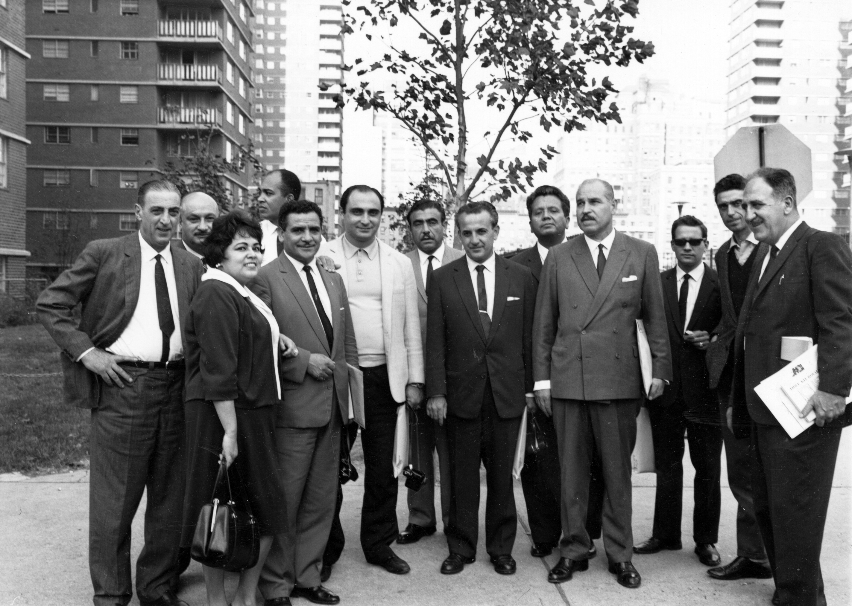 Kathy Andrade standing with a group of men from Chile during a visit to the ILGWU's Penn South cooperative housing community in Chelsea, 1967.