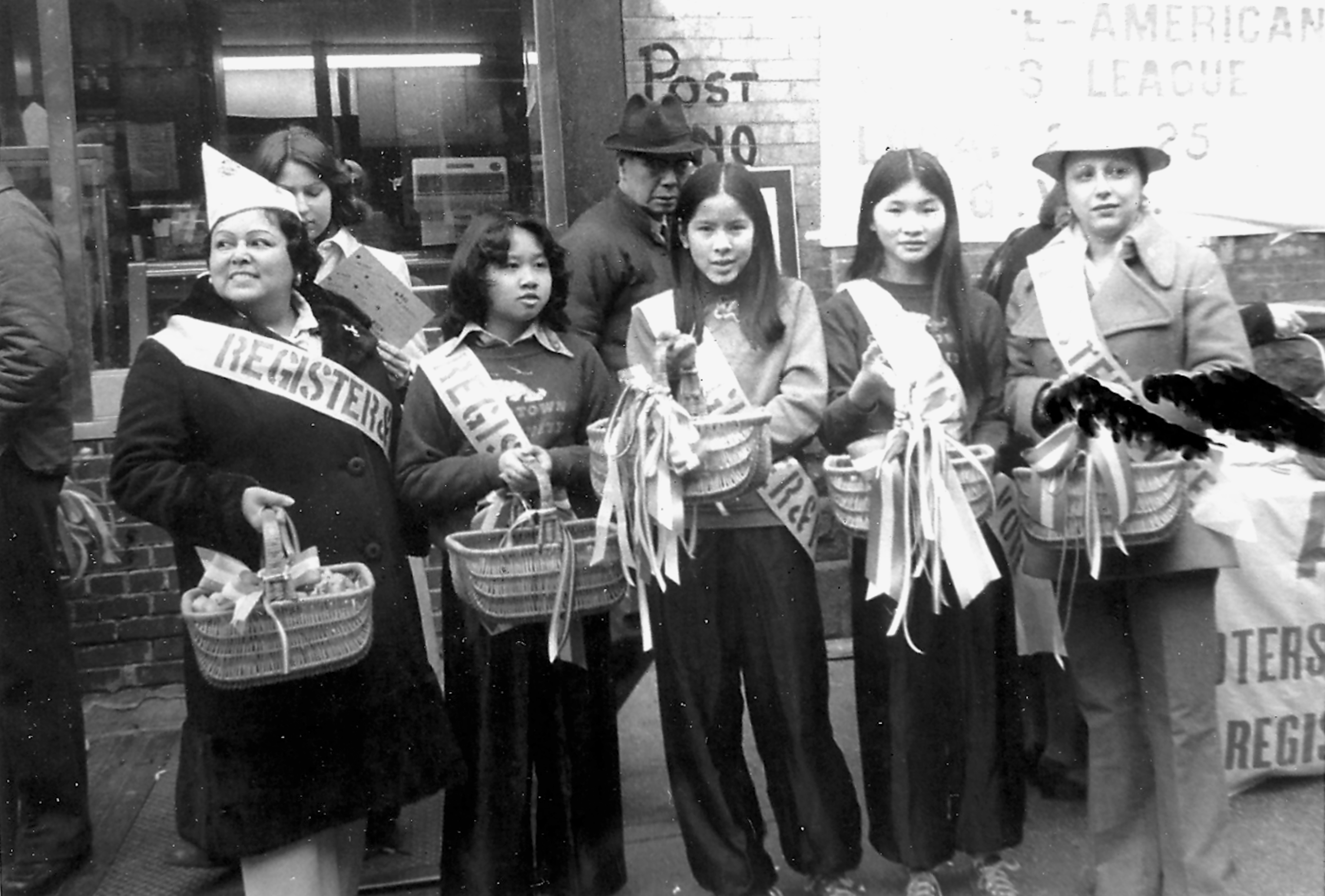Kathy Andrade with members of the Chinese American Voters League in Chinatown, standing with baskets and sashes during a voter registration drive in the 1980s.